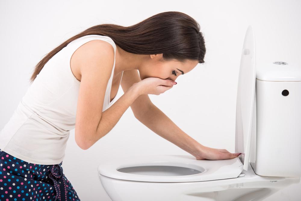 Woman vomiting due to liver cirrhosis
