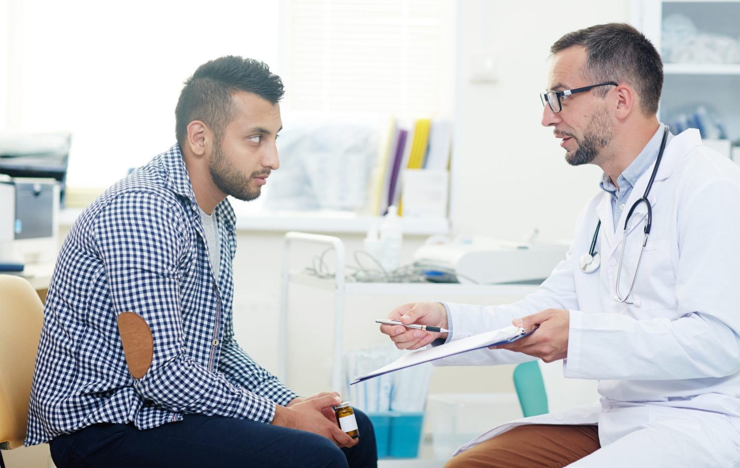 Male doctor offering appointment for Gallbladder stone treatment to a man