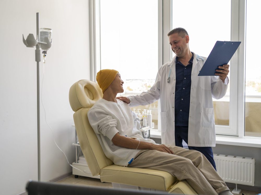 Male doctor talking to patient suffering from colorectal cancer